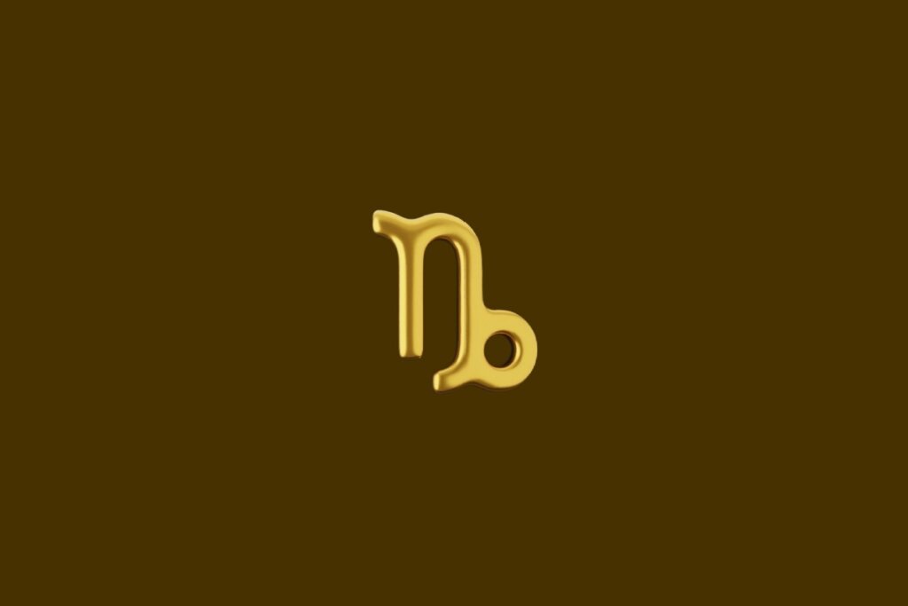 Ilustração do símbolo do signo de Capricórnio dourado em um fundo marrom