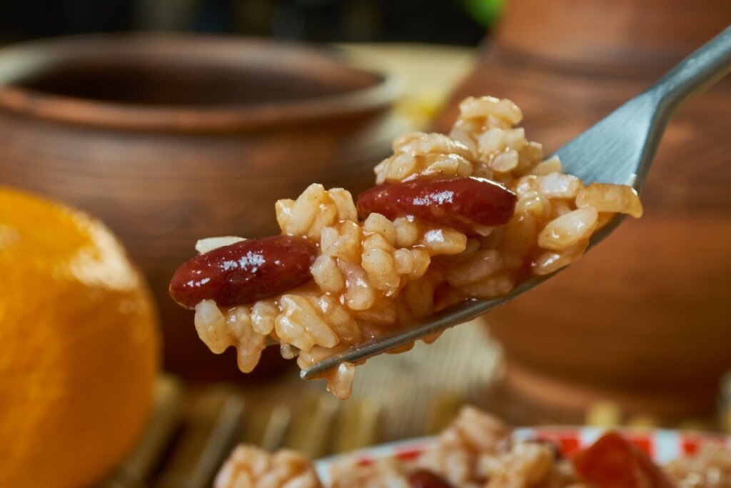 Garfo de metal com arroz e feijão-preto